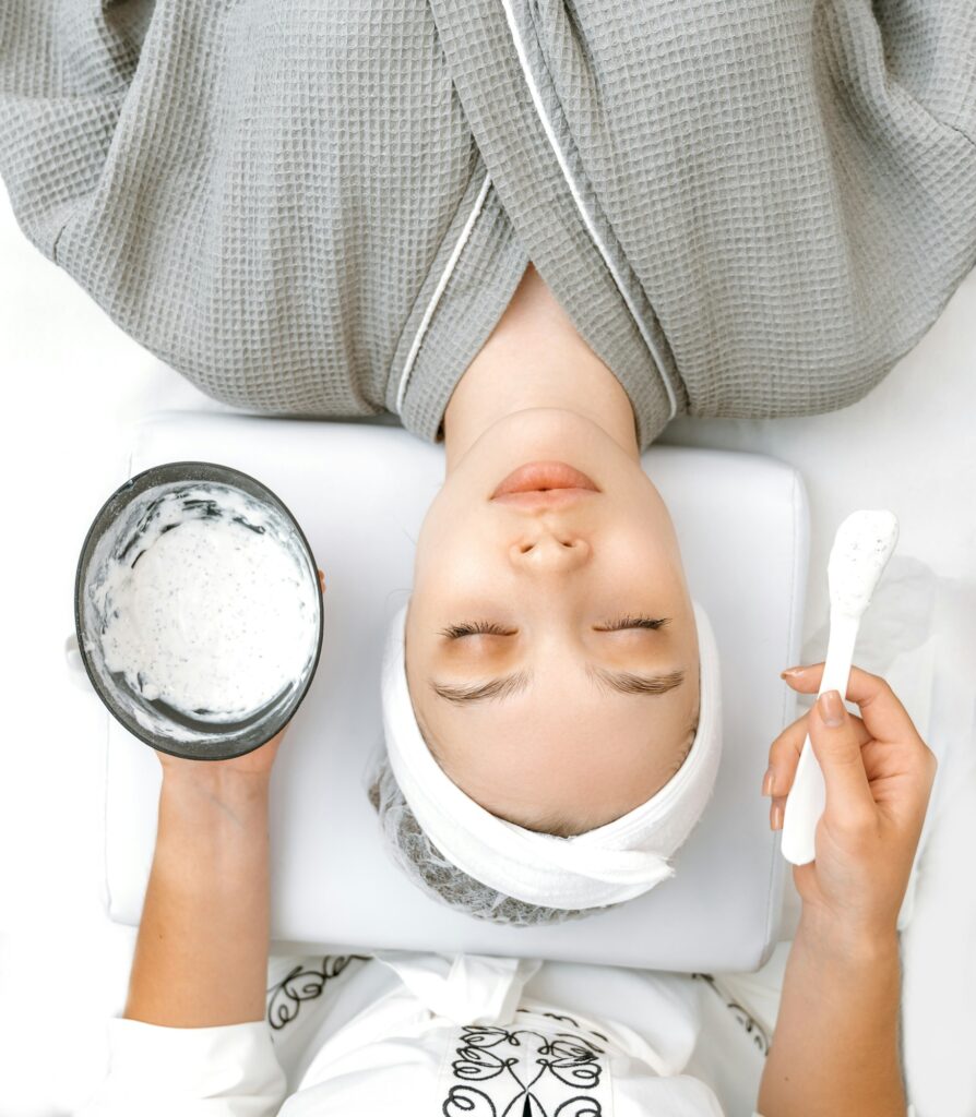 Beauty concept. Vertical top view photo of a caucasian relaxed woman lying in a salon with her eyes