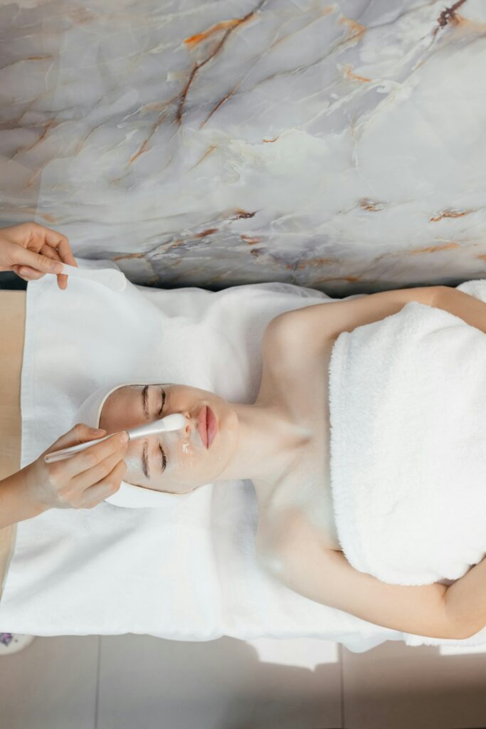 Close-up portrait of woman getting spa facial massage treatment