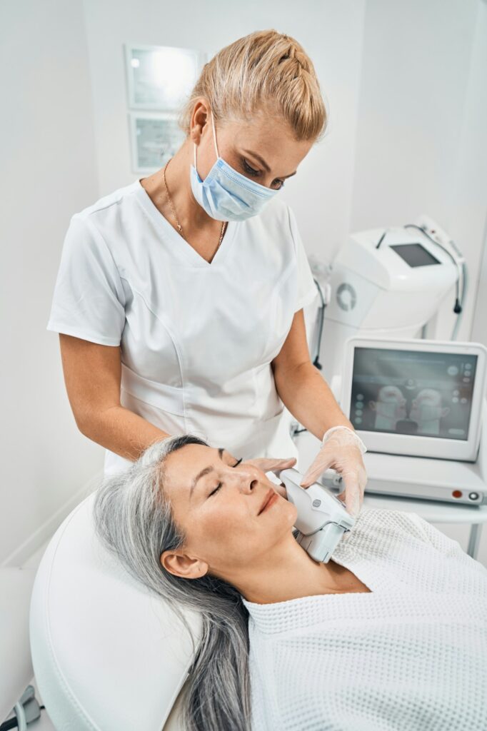 Young blonde woman working in modern beauty clinic